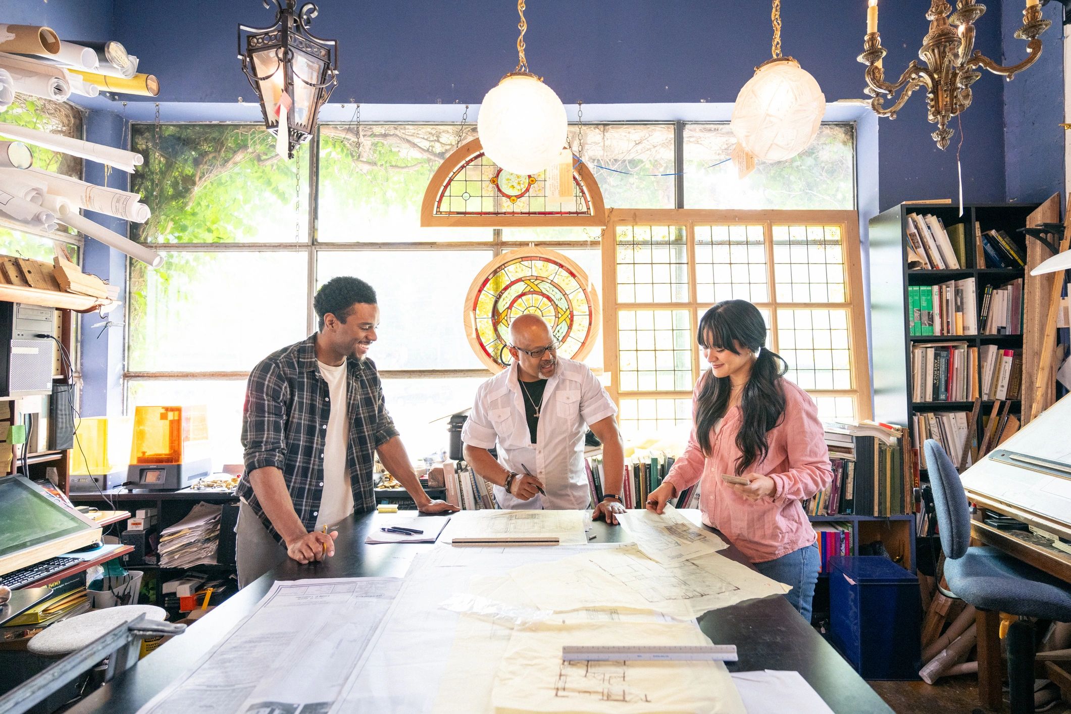 Team of professionals working together in a bright studio
